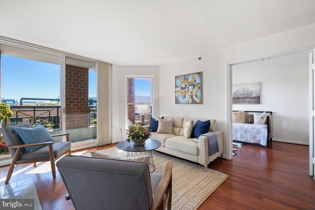 living room with floor to ceiling windows and dark wood-type flooring