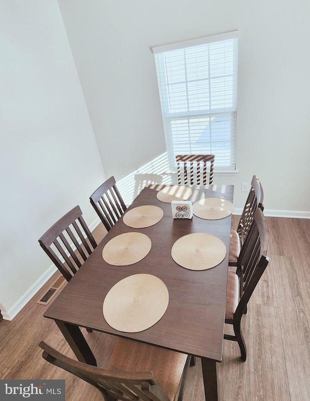 dining space featuring wood-type flooring