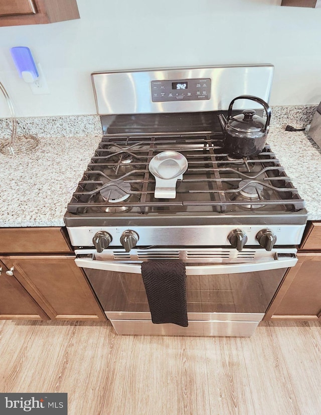 room details with gas range and light stone countertops