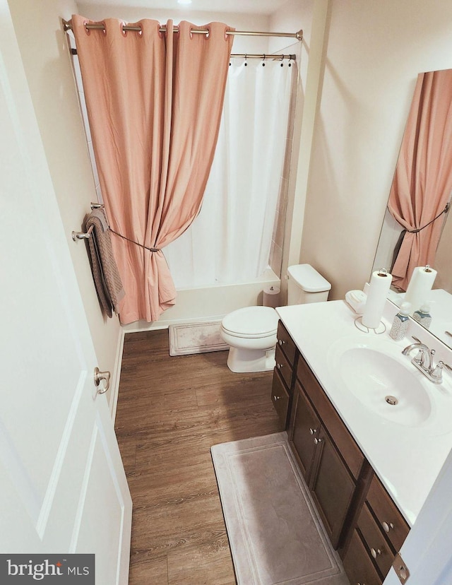 full bathroom featuring vanity, wood-type flooring, shower / bath combo, and toilet