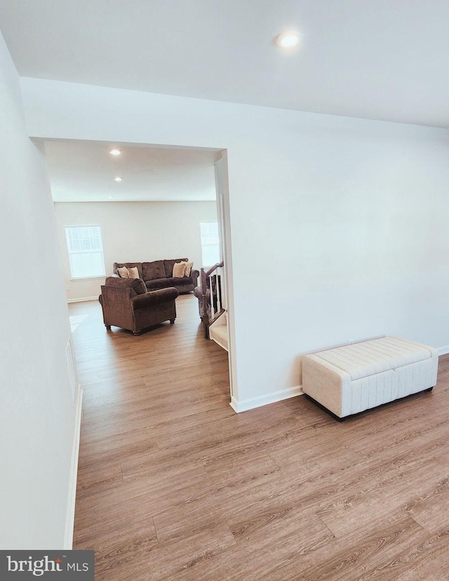 corridor with light hardwood / wood-style flooring