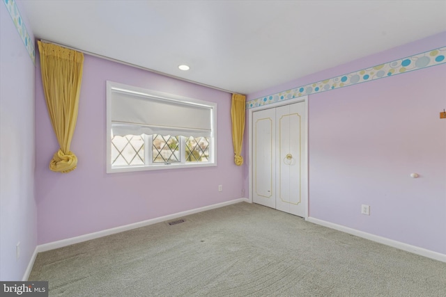 unfurnished bedroom with carpet flooring and a closet