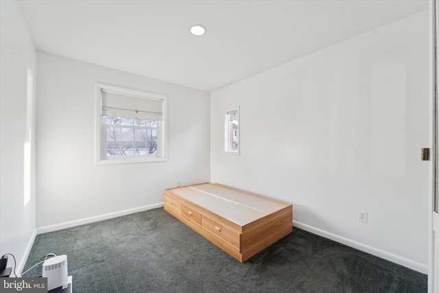 unfurnished bedroom featuring dark carpet