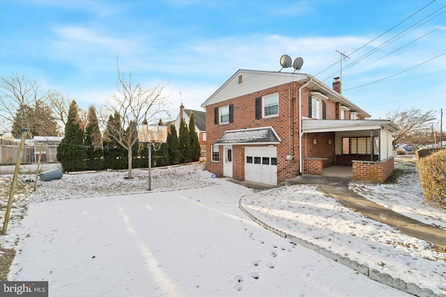 view of snowy exterior featuring covered porch