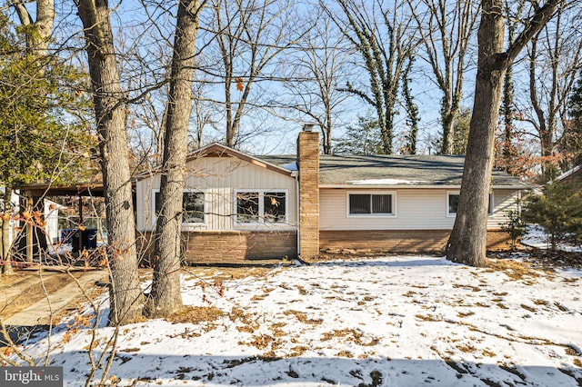 view of snow covered rear of property