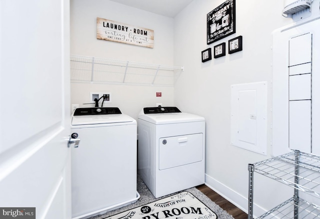 laundry area with independent washer and dryer, dark wood-type flooring, and electric panel