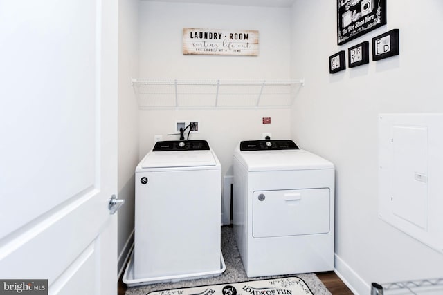 laundry area featuring dark hardwood / wood-style floors, independent washer and dryer, and electric panel