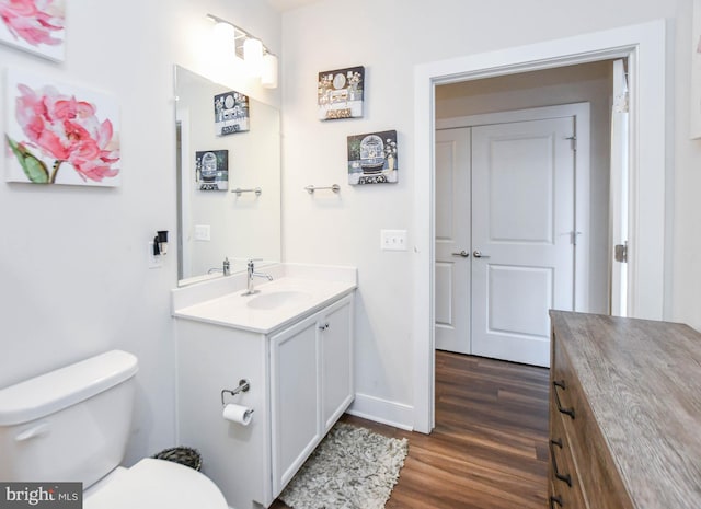 bathroom featuring hardwood / wood-style flooring, vanity, and toilet