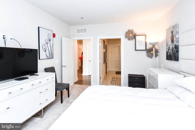 bedroom featuring light carpet