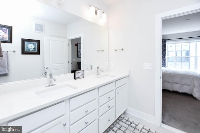 bathroom with tile patterned flooring and vanity