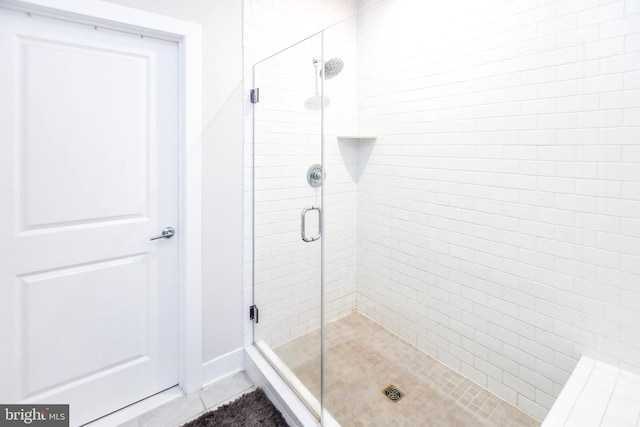 bathroom featuring tile patterned flooring and walk in shower