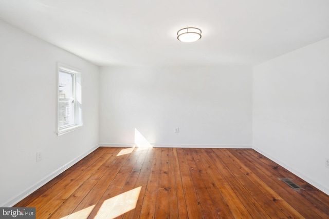 spare room with hardwood / wood-style flooring