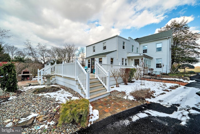 snow covered property featuring a deck