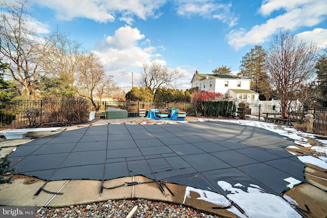 view of swimming pool with a patio, fence, a fenced in pool, and a diving board