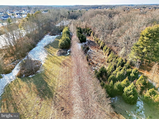 birds eye view of property with a view of trees