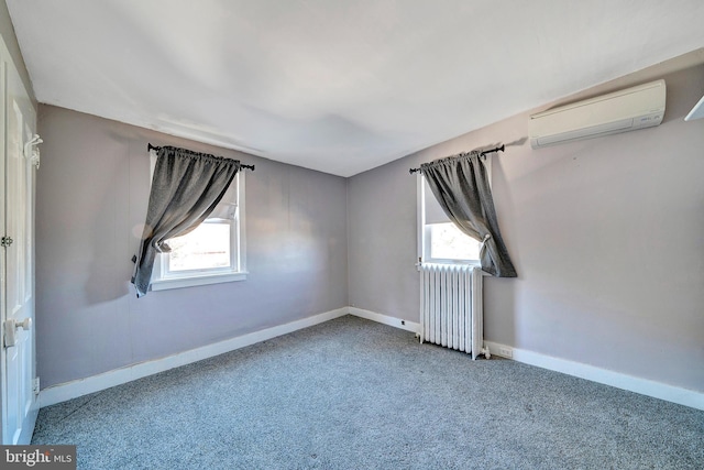 unfurnished room featuring plenty of natural light, radiator, a wall mounted AC, and baseboards