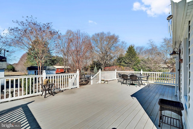 wooden terrace featuring outdoor dining area