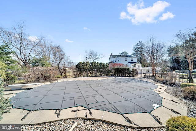 view of pool featuring a diving board, a fenced in pool, a patio area, and fence