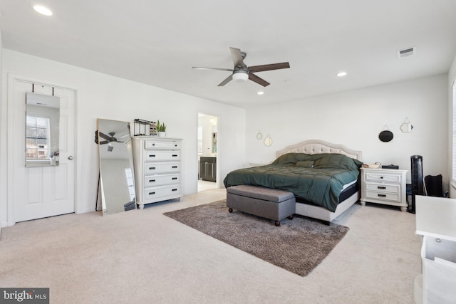 carpeted bedroom featuring ensuite bathroom and ceiling fan