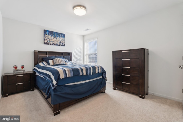 bedroom featuring light carpet