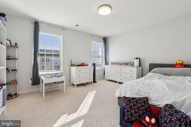 bedroom featuring light carpet