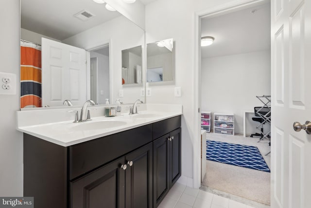 bathroom with tile patterned flooring and vanity