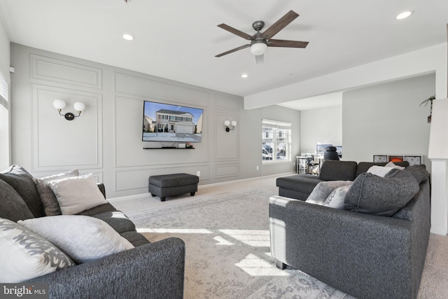 carpeted living room featuring ceiling fan