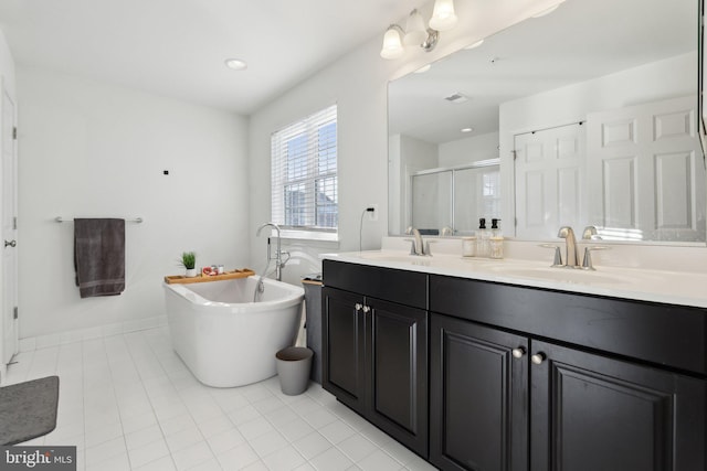 bathroom with tile patterned floors, vanity, and shower with separate bathtub