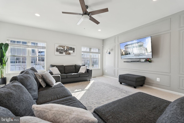 carpeted living room featuring ceiling fan