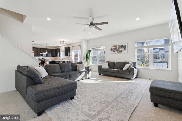 carpeted living room featuring ceiling fan