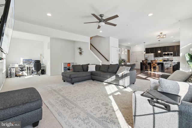 living room with light carpet and ceiling fan