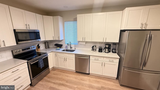 kitchen featuring sink, white cabinets, and appliances with stainless steel finishes