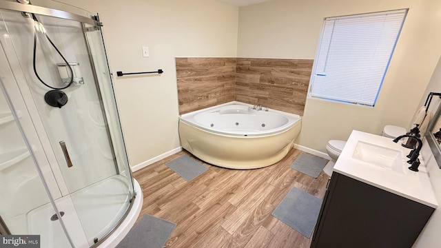 full bathroom with hardwood / wood-style flooring, vanity, toilet, and plus walk in shower