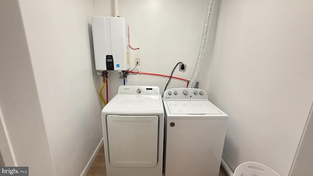 laundry area featuring washing machine and clothes dryer and water heater