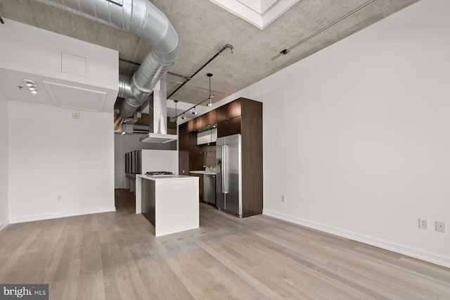 kitchen with stainless steel fridge with ice dispenser, dark brown cabinetry, light hardwood / wood-style flooring, and a kitchen island