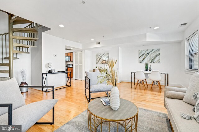 living room with light hardwood / wood-style flooring