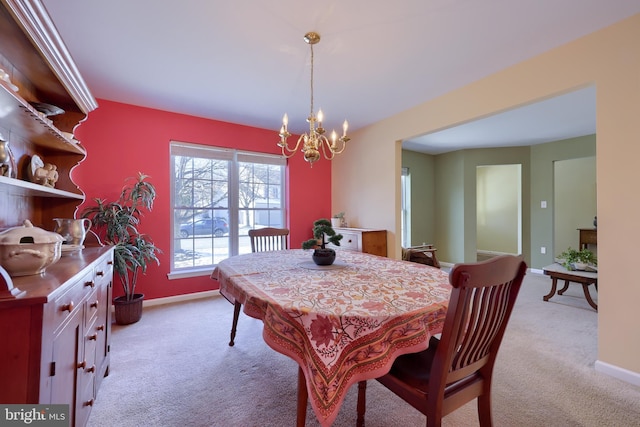 carpeted dining space with a notable chandelier