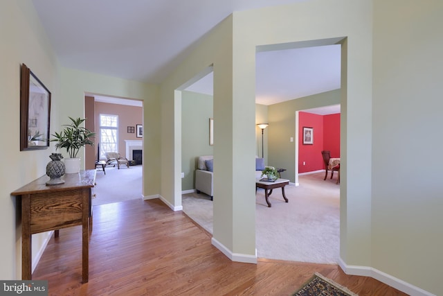 hall featuring light colored carpet