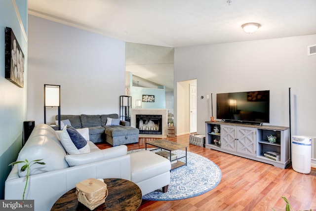 living room with hardwood / wood-style flooring and vaulted ceiling