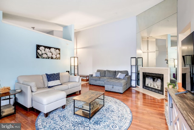 living room with hardwood / wood-style flooring and vaulted ceiling