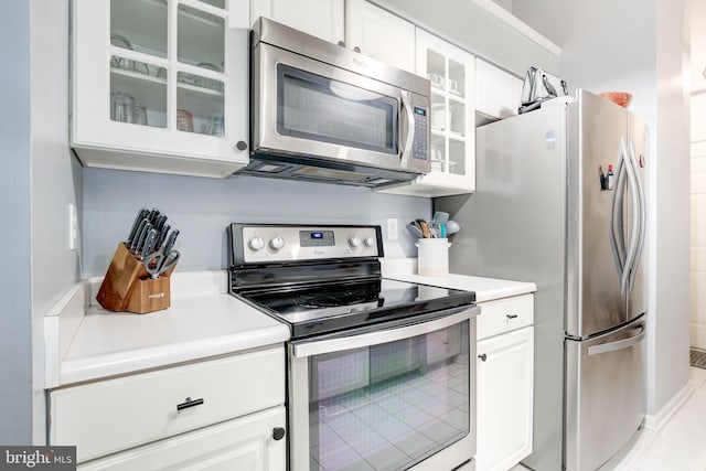 kitchen featuring white cabinetry and appliances with stainless steel finishes