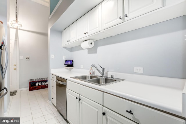 kitchen featuring pendant lighting, white cabinets, sink, light tile patterned floors, and appliances with stainless steel finishes