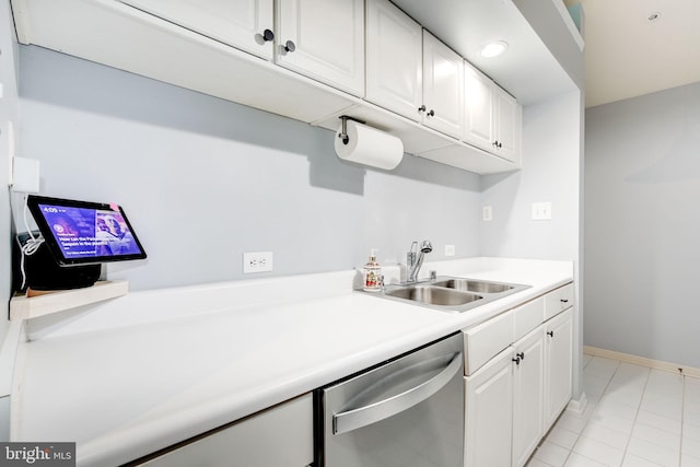 kitchen featuring stainless steel dishwasher, light tile patterned flooring, white cabinets, and sink