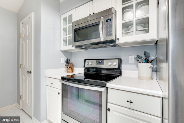 kitchen featuring white cabinets, light tile patterned floors, and appliances with stainless steel finishes