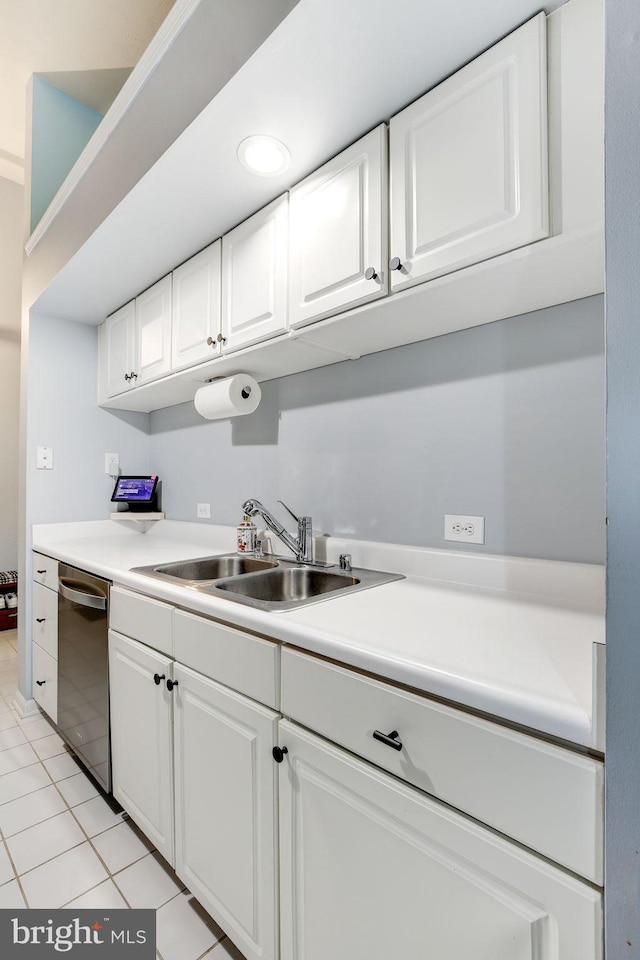 kitchen featuring white cabinetry, dishwasher, light tile patterned floors, and sink