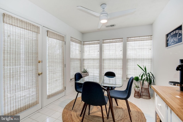 tiled dining area with ceiling fan