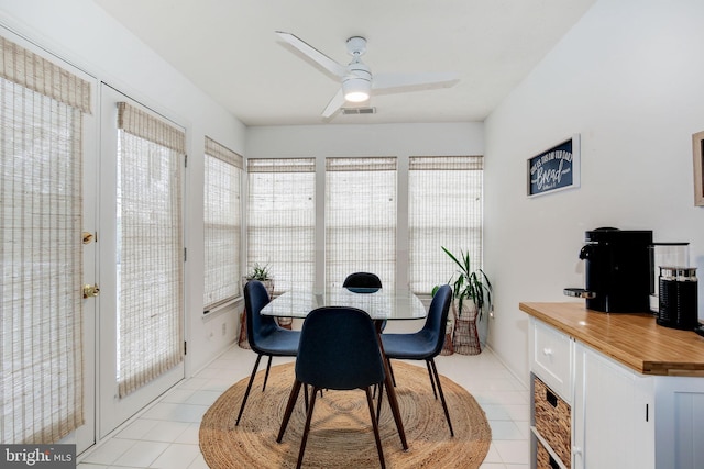 tiled dining area with ceiling fan