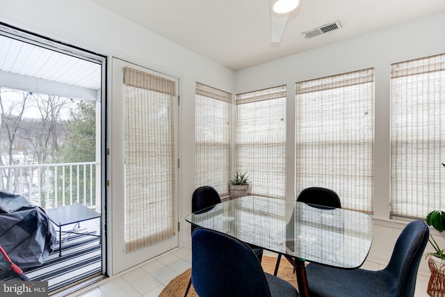 tiled dining area featuring ceiling fan and plenty of natural light