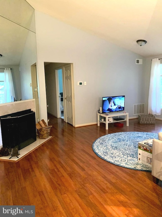 living room featuring hardwood / wood-style floors and lofted ceiling