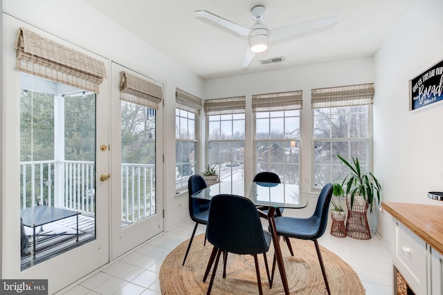 sunroom / solarium featuring ceiling fan